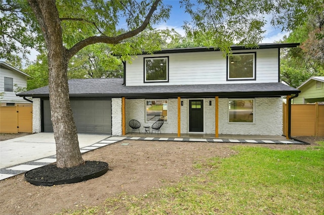 2114 Vanderbilt Ln, Austin, TX 78723 - view of front facade with a garage, concrete driveway, and a porch