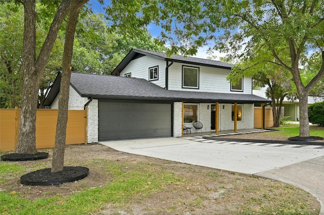 2114 Vanderbilt Ln, Austin, TX 78723 - view of front facade with an attached garage, a porch, concrete driveway, and roof with shingles
