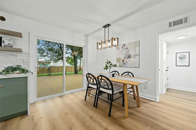 2114 Vanderbilt Ln, Austin, TX 78723 - dining space with light wood finished floors and a chandelier