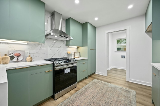 2114 Vanderbilt Ln, Austin, TX 78723 - kitchen with wall chimney exhaust hood, stainless steel range with gas cooktop, green cabinets, light wood-style floors, and decorative backsplash