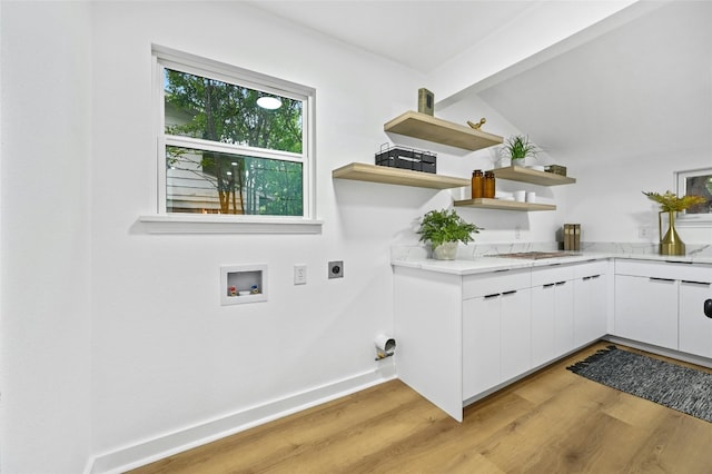 2114 Vanderbilt Ln, Austin, TX 78723 - laundry room featuring hookup for an electric dryer, light wood-style flooring, hookup for a washing machine, and cabinet space