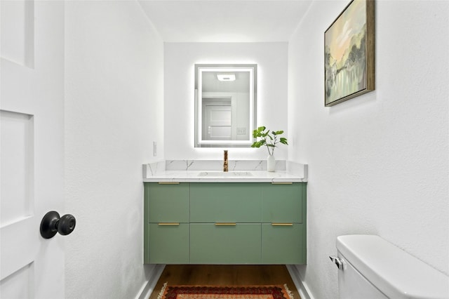 2114 Vanderbilt Ln, Austin, TX 78723 - half bathroom featuring vanity and wood finished floors