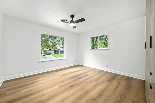 2114 Vanderbilt Ln, Austin, TX 78723 - unfurnished room with plenty of natural light, wood finished floors, and a ceiling fan