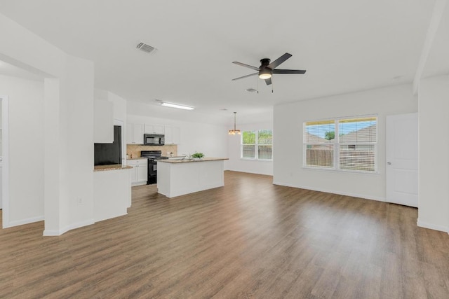 608 Silver Wing Dr, Austin, TX 78725 - unfurnished living room featuring ceiling fan and wood finished floors