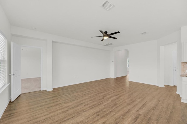 608 Silver Wing Dr, Austin, TX 78725 - unfurnished living room featuring light wood finished floors and a ceiling fan