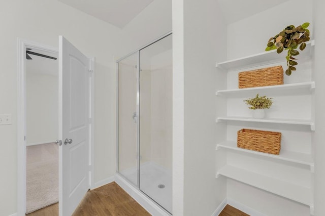 608 Silver Wing Dr, Austin, TX 78725 - bathroom featuring a shower stall and wood finished floors