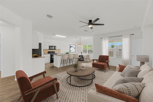 608 Silver Wing Dr, Austin, TX 78725 - living room with light wood-type flooring and a ceiling fan