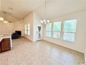 5413 Sandstone Dr, Temple, TX 76502 - unfurnished dining area featuring vaulted ceiling, a fireplace, and a chandelier