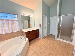 5413 Sandstone Dr, Temple, TX 76502 - full bathroom featuring vanity, a garden tub, a stall shower, lofted ceiling, and tile patterned floors