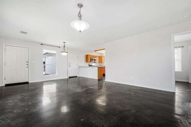 613 Broken Bow Dr, Round Rock, TX 78681 - unfurnished living room featuring concrete flooring and healthy amount of natural light