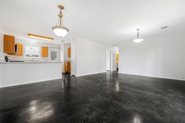613 Broken Bow Dr, Round Rock, TX 78681 - unfurnished living room with finished concrete floors and baseboards