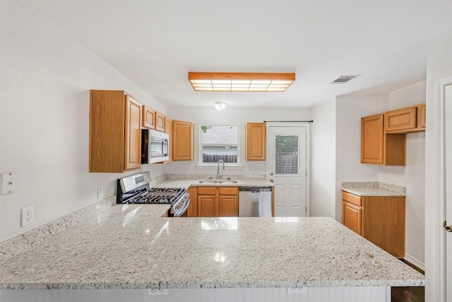 613 Broken Bow Dr, Round Rock, TX 78681 - kitchen with appliances with stainless steel finishes, a peninsula, and light stone countertops