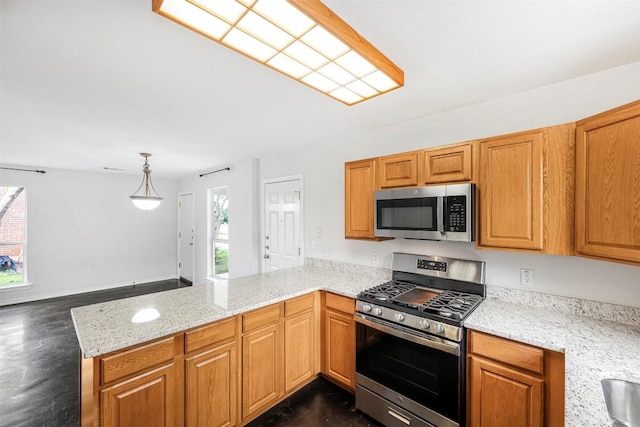 613 Broken Bow Dr, Round Rock, TX 78681 - kitchen featuring stainless steel appliances, a peninsula, light stone countertops, and dark wood-style flooring