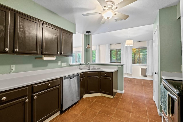 13402 Briar Hollow Dr, Austin, TX 78729 - kitchen featuring appliances with stainless steel finishes, dark brown cabinetry, a peninsula, light countertops, and a ceiling fan