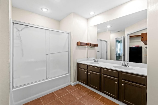 13402 Briar Hollow Dr, Austin, TX 78729 - full bathroom with double vanity, tile patterned flooring, combined bath / shower with glass door, and recessed lighting
