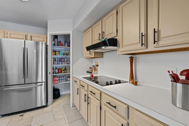 3011 Wadsworth Way, Austin, TX 78748 - kitchen with freestanding refrigerator, under cabinet range hood, black electric stovetop, and cream cabinets