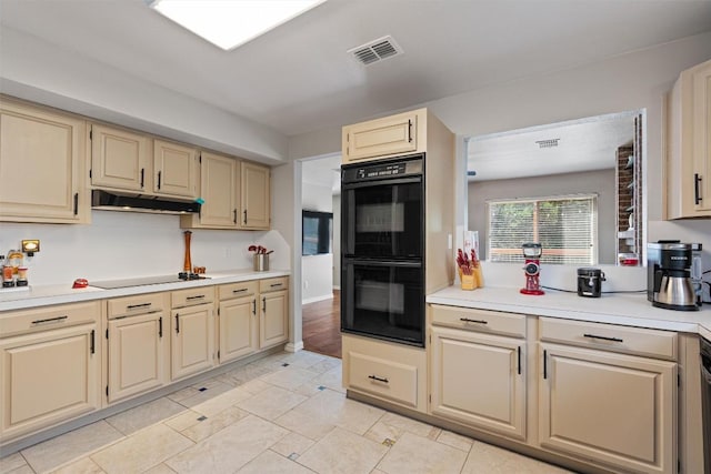 3011 Wadsworth Way, Austin, TX 78748 - kitchen with black appliances, light countertops, cream cabinets, and under cabinet range hood