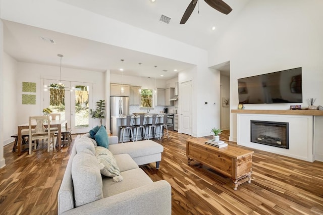 10129 Longhorn Skwy, Dripping Springs, TX 78620 - living area with a ceiling fan, wood finished floors, a fireplace, recessed lighting, and a high ceiling