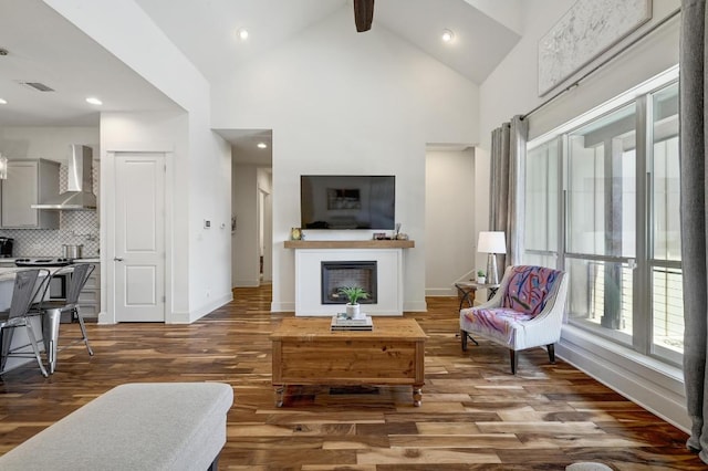 10129 Longhorn Skwy, Dripping Springs, TX 78620 - living room with wood finished floors, a fireplace, high vaulted ceiling, beamed ceiling, and recessed lighting