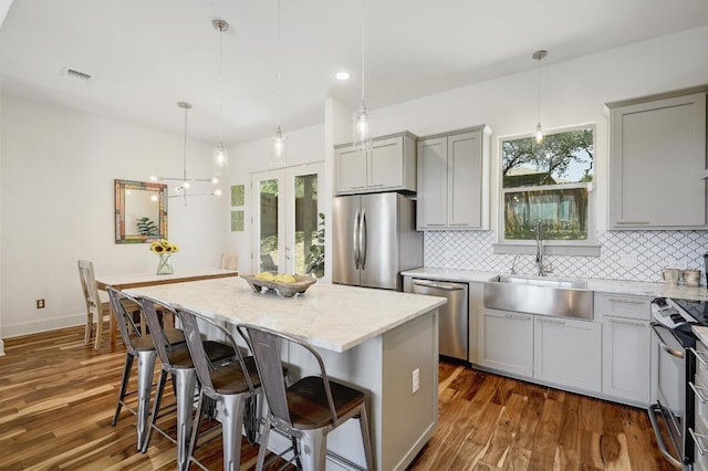 10129 Longhorn Skwy, Dripping Springs, TX 78620 - kitchen featuring stainless steel appliances, gray cabinetry, decorative backsplash, dark wood-style flooring, and recessed lighting