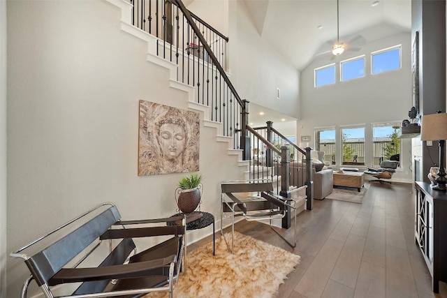 1113 Spring Gulch Ln, Georgetown, TX 78628 - staircase with hardwood / wood-style floors, high vaulted ceiling, and ceiling fan