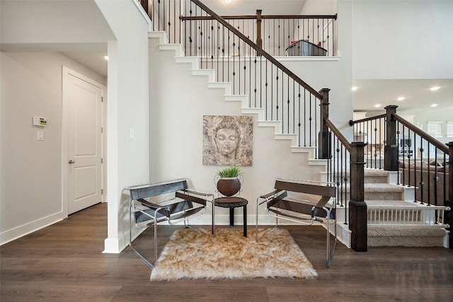 1113 Spring Gulch Ln, Georgetown, TX 78628 - stairway with wood finished floors, a towering ceiling, arched walkways, and recessed lighting