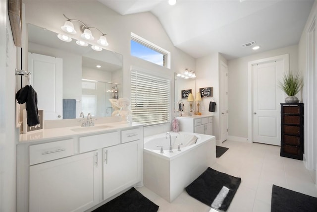 1113 Spring Gulch Ln, Georgetown, TX 78628 - bathroom featuring a stall shower, two vanities, a bath, lofted ceiling, and tile patterned flooring