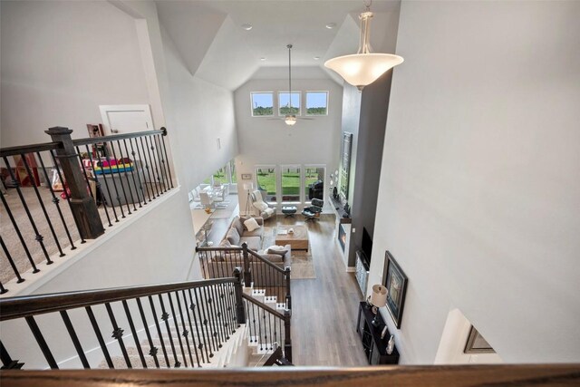 1113 Spring Gulch Ln, Georgetown, TX 78628 - staircase featuring high vaulted ceiling, wood finished floors, and ceiling fan