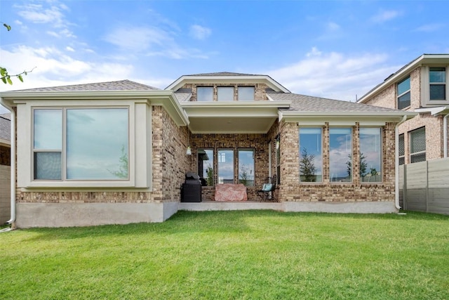 1113 Spring Gulch Ln, Georgetown, TX 78628 - back of property featuring a lawn, brick siding, and roof with shingles