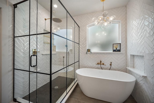 7308 Black Mountain Dr, Austin, TX 78736 - full bath with a chandelier, a soaking tub, tile walls, and a shower stall