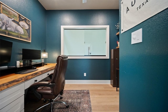 7308 Black Mountain Dr, Austin, TX 78736 - home office with light wood-style floors and a textured wall