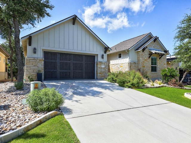 217 Skipping Cedar St, San Marcos, TX 78666 - view of front of property with stone siding, board and batten siding, concrete driveway, and a garage