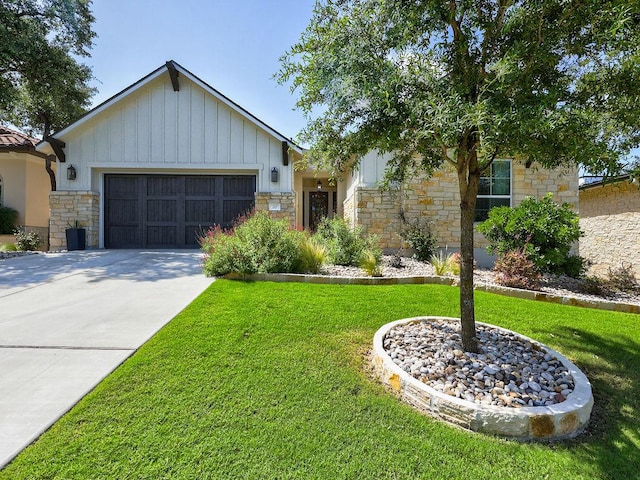 217 Skipping Cedar St, San Marcos, TX 78666 - view of front of property featuring stone siding, an attached garage, a front lawn, and concrete driveway