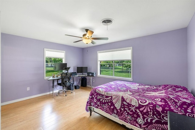 420 Hale St, Lexington, TX 78947 - bedroom with wood finished floors, a desk, and a ceiling fan