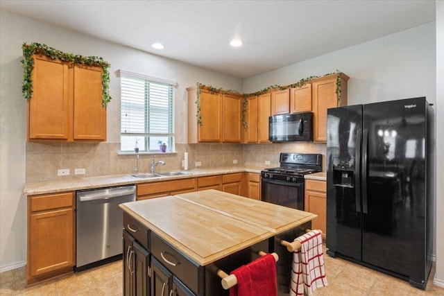 2025 Cliffbrake Way, Georgetown, TX 78626 - kitchen with black appliances, decorative backsplash, recessed lighting, a kitchen island, and light tile patterned floors