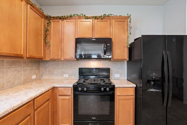 2025 Cliffbrake Way, Georgetown, TX 78626 - kitchen with black appliances, light countertops, and tasteful backsplash