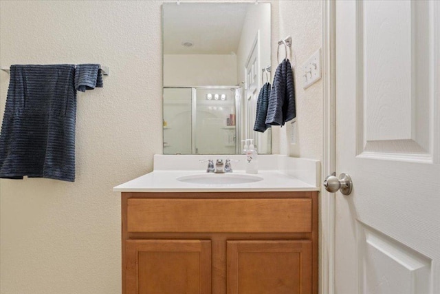 2025 Cliffbrake Way, Georgetown, TX 78626 - full bathroom with vanity, a stall shower, and a textured wall