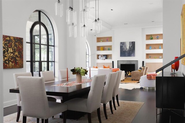 5301 Maryanna Dr, Austin, TX 78746 - dining room featuring built in shelves, a fireplace, and wood finished floors