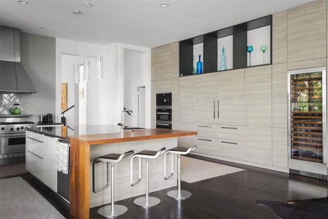 5301 Maryanna Dr, Austin, TX 78746 - kitchen featuring modern cabinets, beverage cooler, high end range, wall chimney range hood, and backsplash