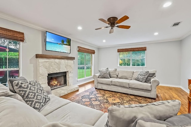 2802 Brandy Ln, Georgetown, TX 78628 - living area with wood finished floors, crown molding, a ceiling fan, recessed lighting, and a fireplace