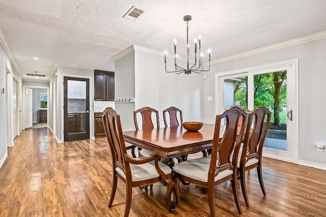 2802 Brandy Ln, Georgetown, TX 78628 - dining area with light wood-type flooring, plenty of natural light, a chandelier, and ornamental molding