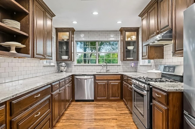 2802 Brandy Ln, Georgetown, TX 78628 - kitchen featuring stainless steel appliances, under cabinet range hood, light wood-type flooring, light stone countertops, and recessed lighting