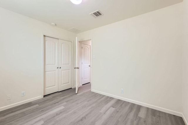 1436 Biscuit Dr, Austin, TX 78754 - unfurnished bedroom with light wood finished floors and a closet