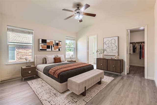 1436 Biscuit Dr, Austin, TX 78754 - bedroom with light wood finished floors, a spacious closet, lofted ceiling, a ceiling fan, and a closet