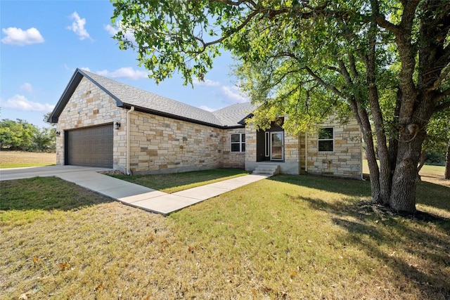 106 Chaumont St, Kingsland, TX 78639 - view of front of home featuring stone siding, an attached garage, a front lawn, and concrete driveway