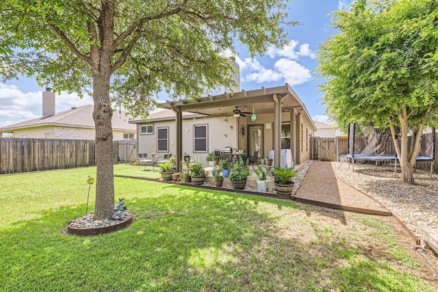 803 Ranchero Rd, Leander, TX 78641 - rear view of property featuring a ceiling fan, a trampoline, a patio, a fenced backyard, and stucco siding
