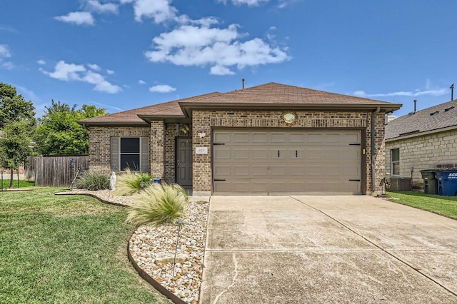 803 Ranchero Rd, Leander, TX 78641 - view of front facade with brick siding, driveway, an attached garage, and a shingled roof