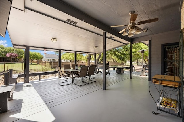 401 N Fox Xing, Burnet, TX 78611 - fenced backyard featuring outdoor dining area, a ceiling fan, and a wooden deck