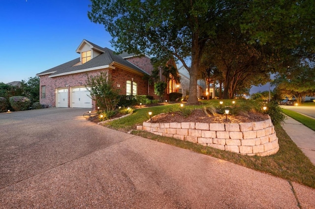 10008 Inshore Dr, Austin, TX 78730 - view of front of home featuring driveway, brick siding, and an attached garage