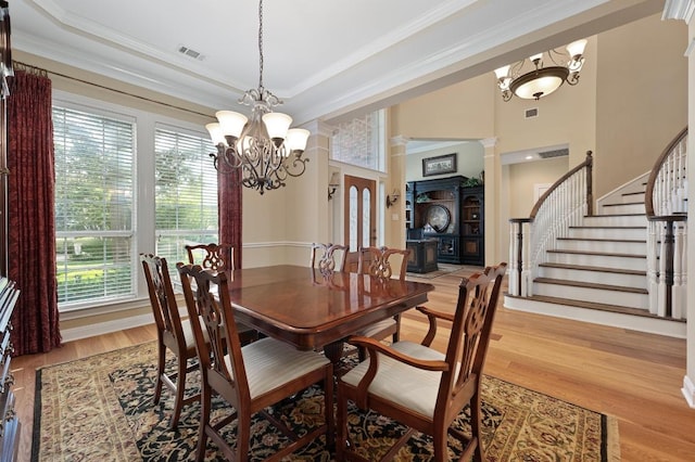 10008 Inshore Dr, Austin, TX 78730 - dining space featuring a chandelier, plenty of natural light, ornamental molding, light wood finished floors, and stairs